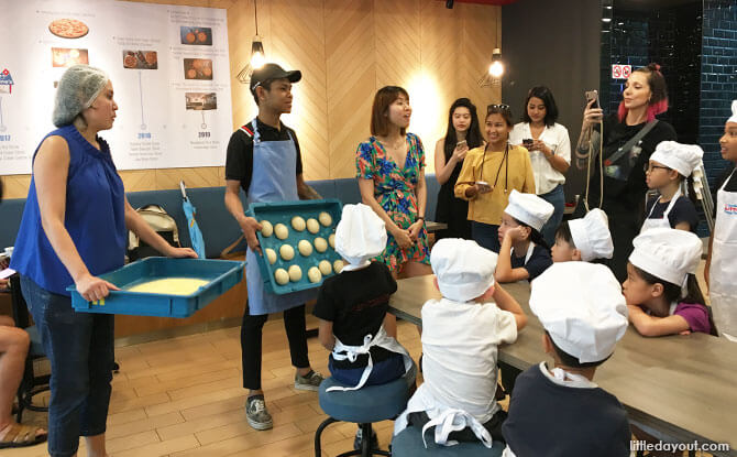 The kids were going to transform the balls of dough that Boy was holding into personal pan Hawaiian Paradise Pizzas!