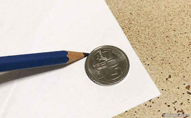 Take the 50 cent coin and trace two circles of that size and cut it out.