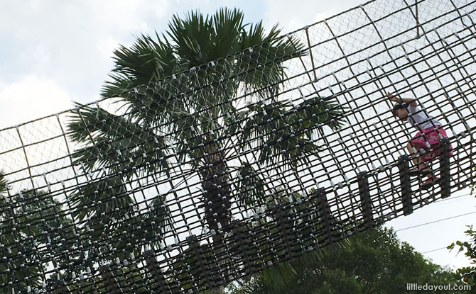 Climbing along the net bridges at Nestopia Singapore