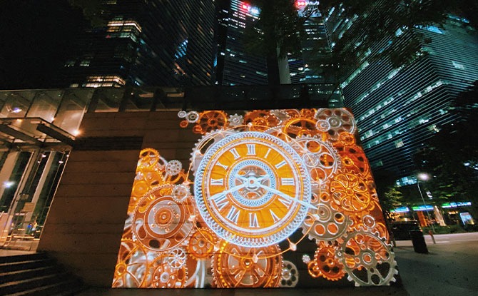 Colourful Light Installations Illuminate The Marina Bay Waterfront This December 2 clockface projection display