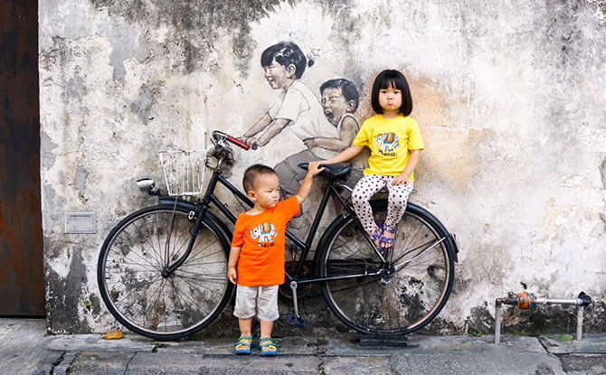 Little Chow and Littler Chow unhappy about an “unreal” bicycle, Penang, Malaysia. Image: Stefan Chow.