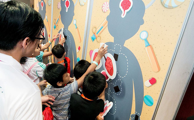 Little ones learn about body anatomy as they place the correct organs on life-sized body silhouettes.- Gleneagles Hospital Singapore 60th anniversary carnival