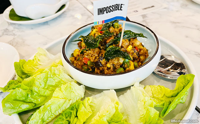 Sautéed Minced Impossible Pork with Basil served with Romaine Lettuce