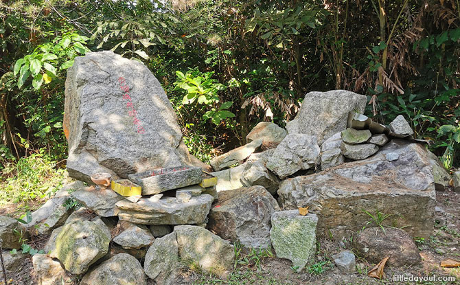 pile of rocks across the entrance of the little shrine