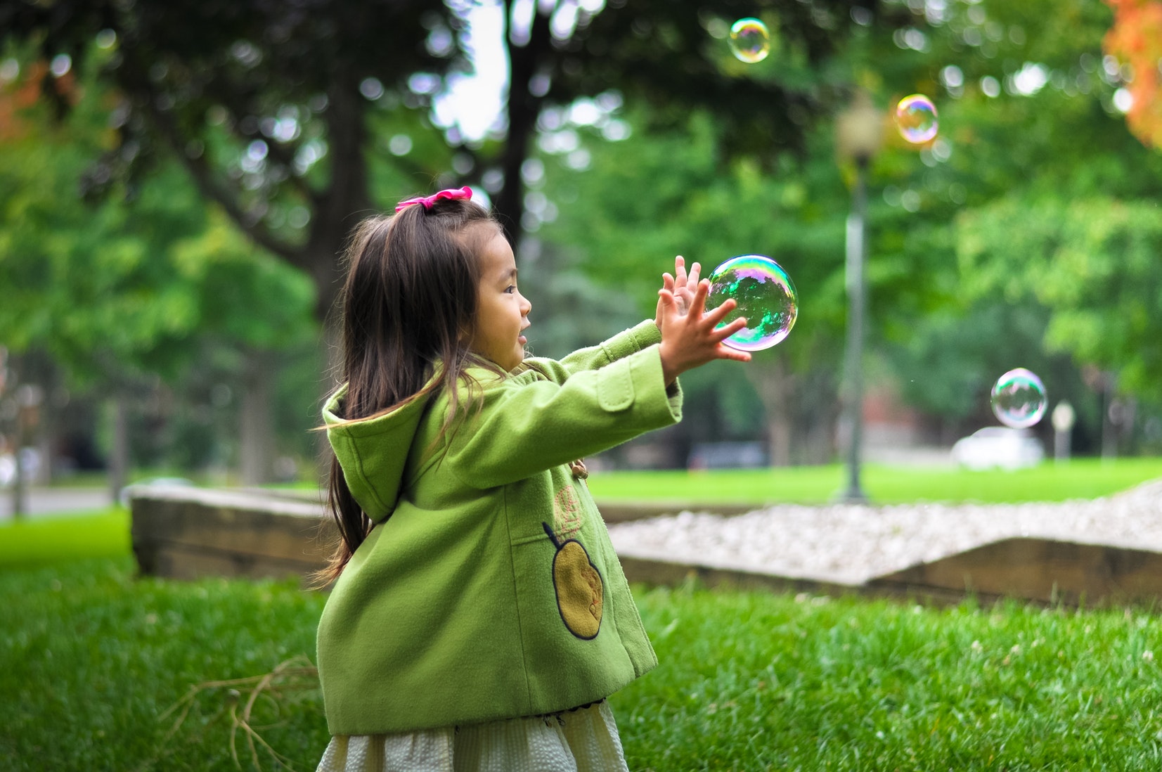 Young girl playing with bubble