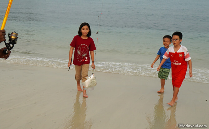 The kids were awed by how an angler caught a fish at the beach.