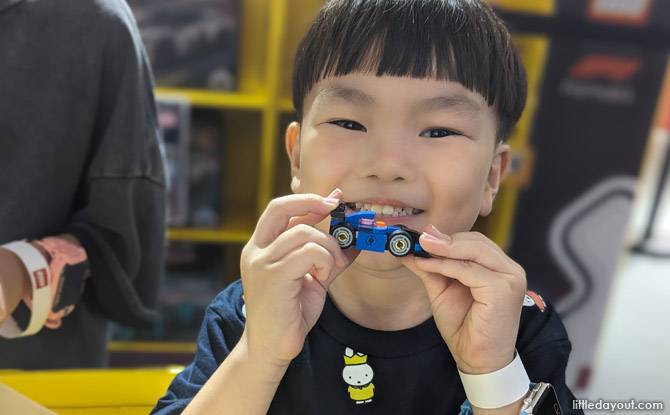 redeem a prize of either a mini LEGO race car (for kids aged 4-12, or a $5 LEGO voucher)