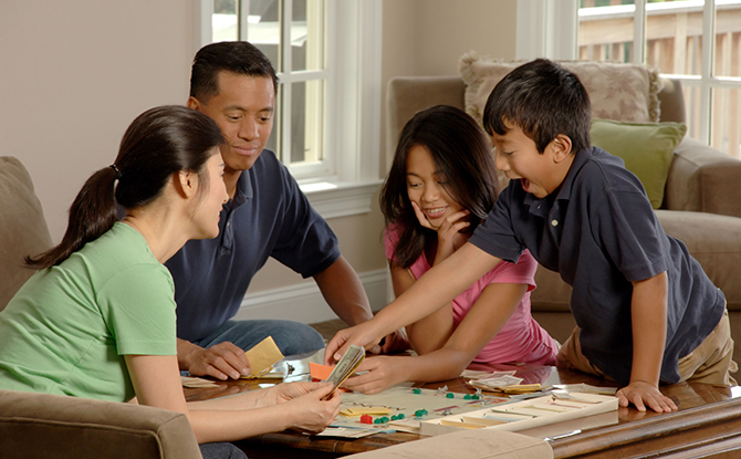 how to teach your child about money through play, playing board games