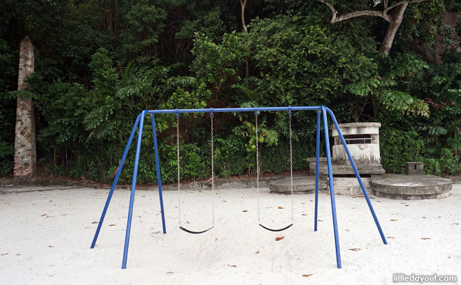 Swings at Labrador Park with a machine gun nest and a navigational marker in the background