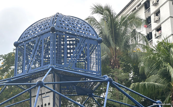 Circle Green Park: Three Playgrounds Including A Climbing Pyramid 2 blue “house” at the top of the Circle Green Park playground