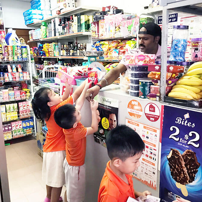 Children making real purchases at a nearby mama shop.