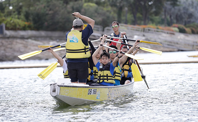 Attendees trying their hand at Dragonboating during the Let's Play event.