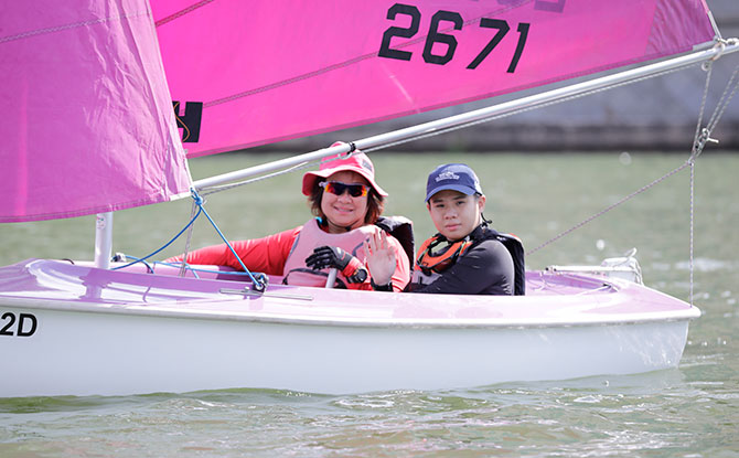 Desiree Lim, Team Singapore sailor, taking event attendee Hansa Sailing during Lets Play at PAssion WaVe@Marina Bay.