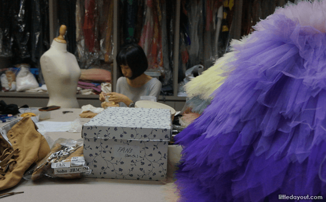 A stylist hard at work in the busy wardrobe room