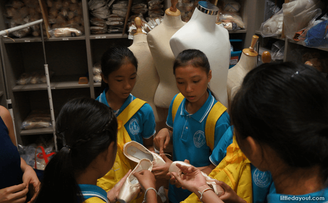 Examining the shoes to tell the difference between those made for dancers with two longer toes and four even-lengthed toes