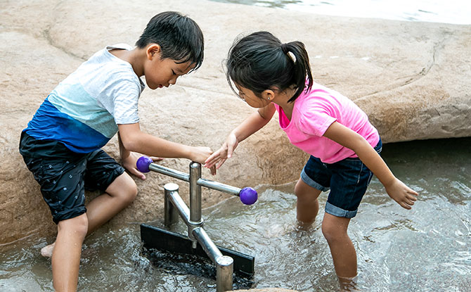 Children interacting with tidal gates.