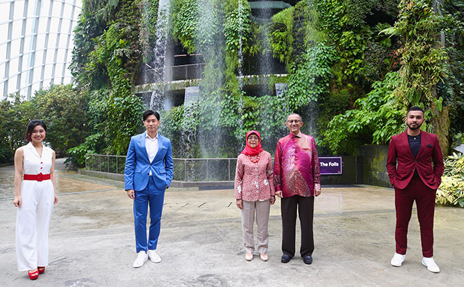 From left to right: Mediacorp artistes JJ Neo, Desmond Tan, President Halimah Yacob, Mr Mohamed Abdullah Alhabshee, and singer Taufik Batisah at the filming and recording of "Home" in Gardens by the Bay’s Cloud Forest. Image: Ministry of