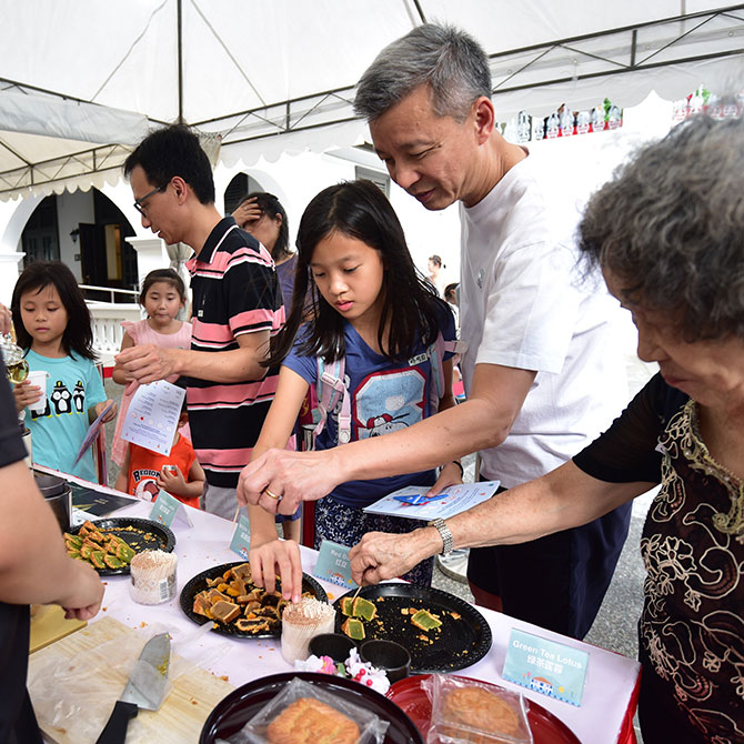 Visitors indulge in tea and mooncakes at a booth presented by Kwong Cheong Thye and Camelia Tea Bar at Sun Yat Sen Nanyang Memorial Hall. Image courtesy of Sun Yat Sen Nanyang Memorial Hall.