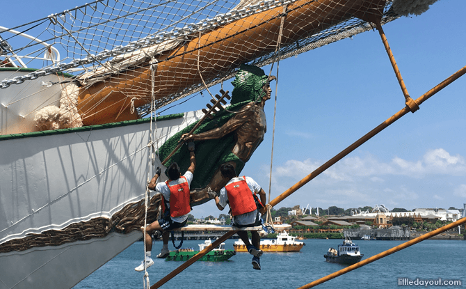 Sailors cleaning the figurehead