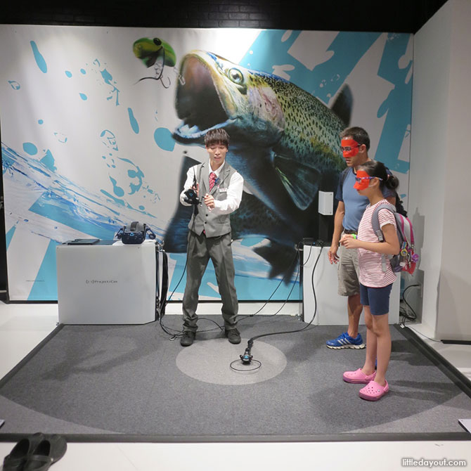 Staff teaching us how to fish at the VR Zone Osaka