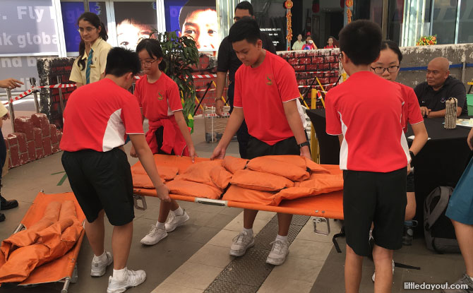 Using a stretcher at the SCDF Showcase, S'pore Discovery Centre