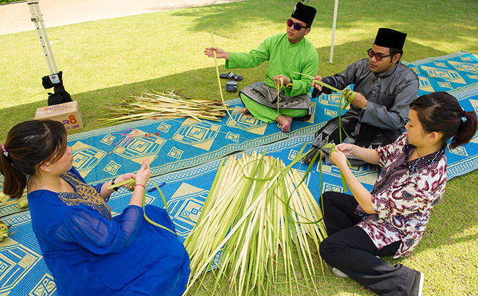 People weaving leaves 