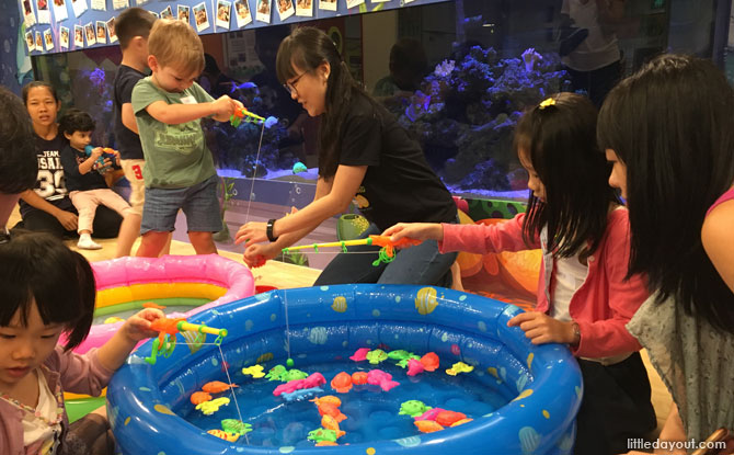 Families enjoyed bonding moments at the fishing activity station.