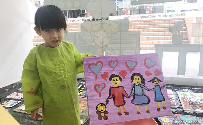 Girl holding painting