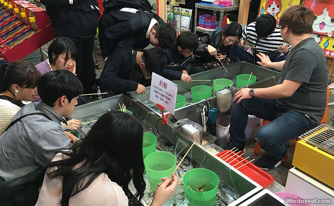 Catching prawns to eat at Shilin Night Market, Taipei, Taiwan