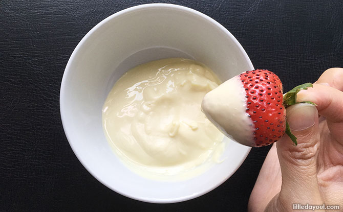 Dip each strawberry into the molten white chocolate