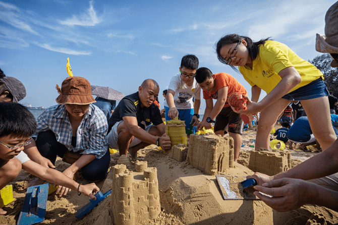 Learning teamwork through sandcastle building at Castle Beach