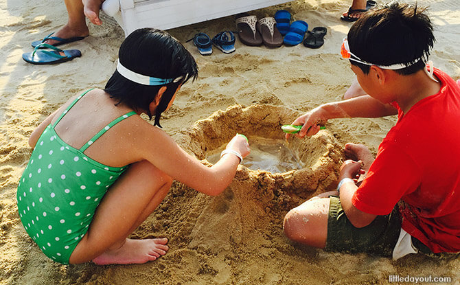 Kids playing with sand at The Canopi Resort, Bintan