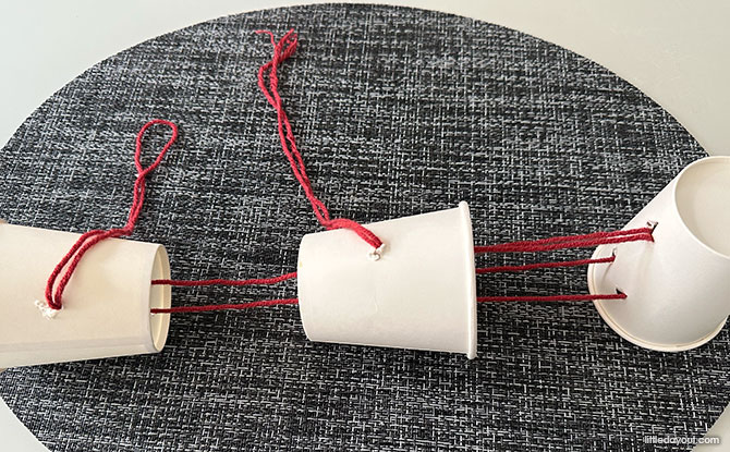 Lion Dance Craft (With Free Template) 4 string the yarn through the cups