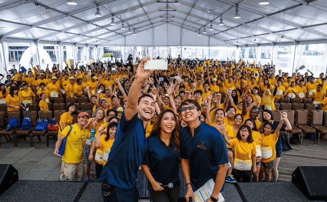 Emcees Paul Foster, Charmaine Yee and Glenn Ong gathering the crowd for a ‘WeFie’ at Play It Forward 2016