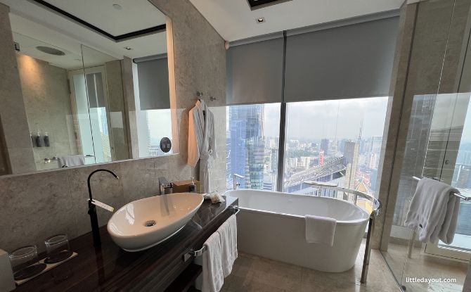 The Westin Singapore Family Weekend Staycation Review: Rediscover Local With Your Wellness at Heart 5 beautiful skylit marble bathroom with the City Skyline view.